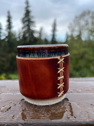Handmade cups that are wrapped with some custom leatherwork